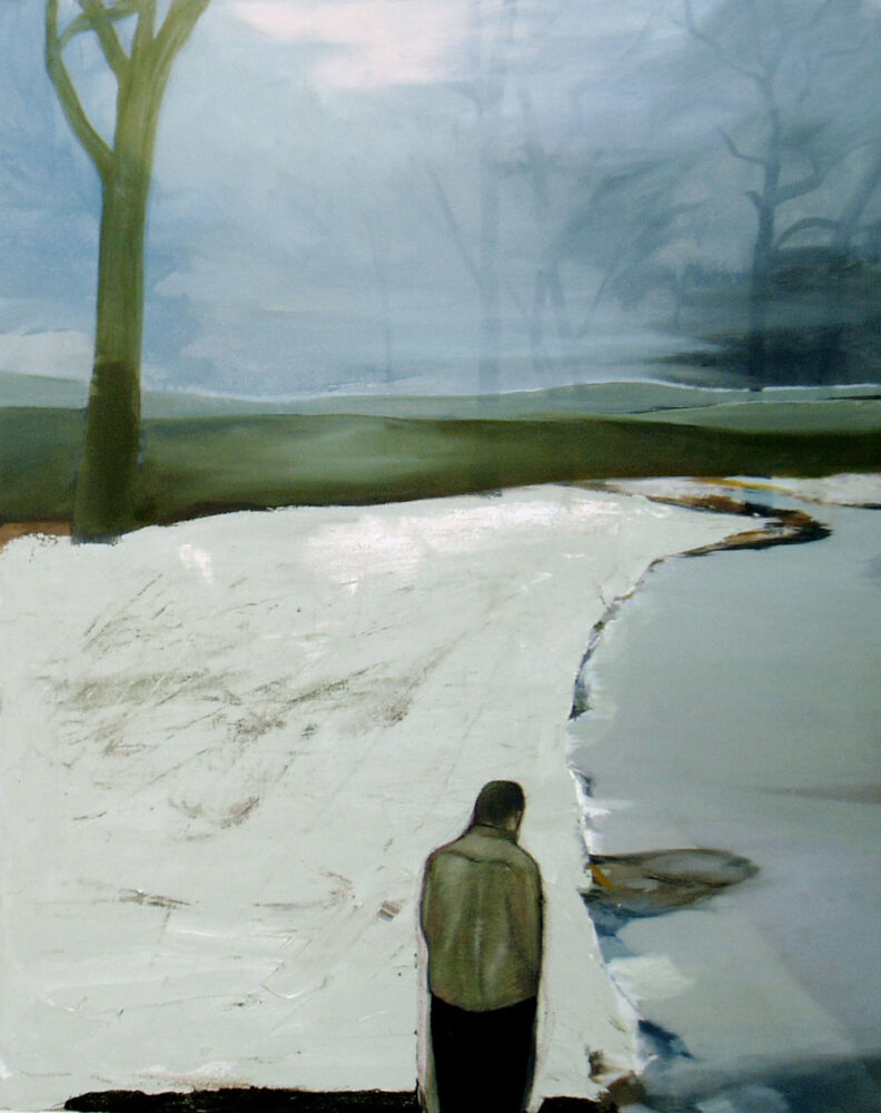 Ein Mann steht vor einer blassgrauen Winterlandschaft